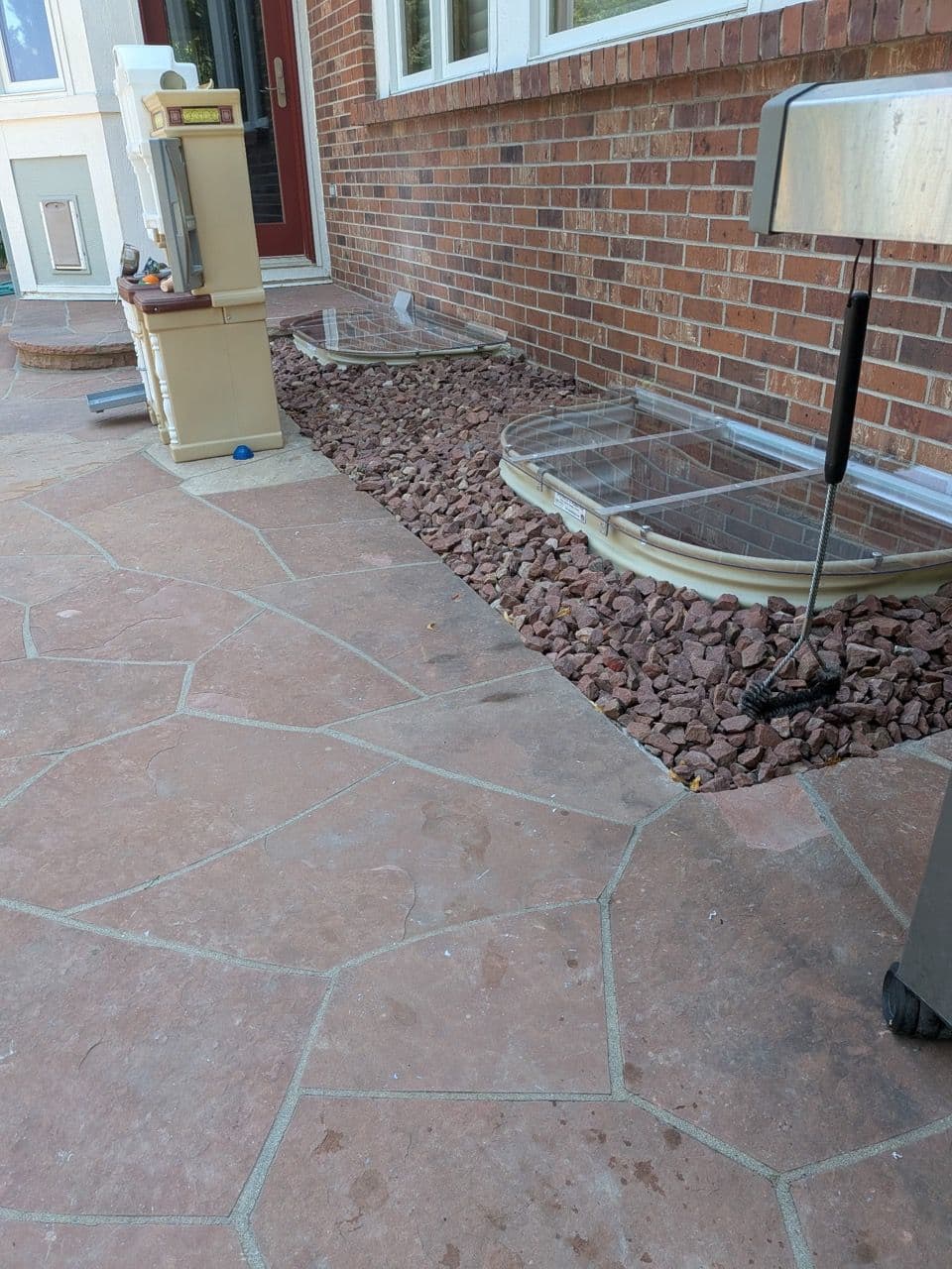 Project Enhanced Patio Experience with New Window Wells and Flagstone image